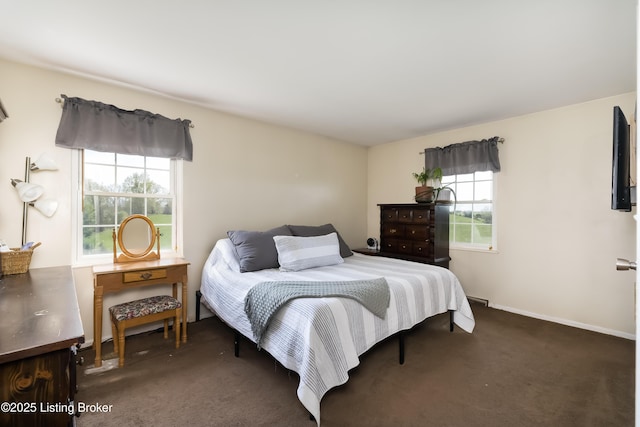 carpeted bedroom featuring baseboards