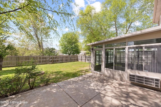 view of patio with a sunroom and a fenced backyard