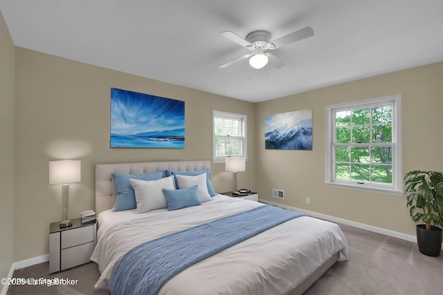 carpeted bedroom featuring visible vents, ceiling fan, and baseboards