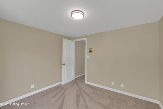 empty room with baseboards and carpet floors