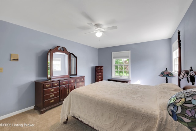 bedroom featuring ceiling fan, baseboards, and light carpet
