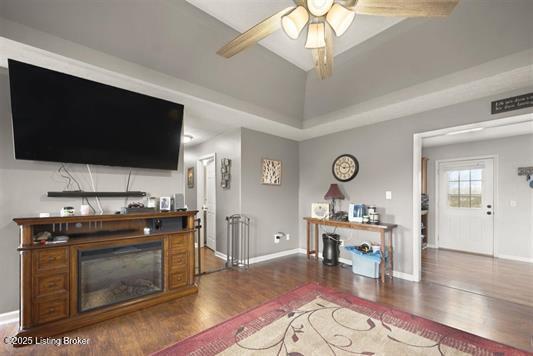 living room with wood finished floors, ceiling fan, and baseboards