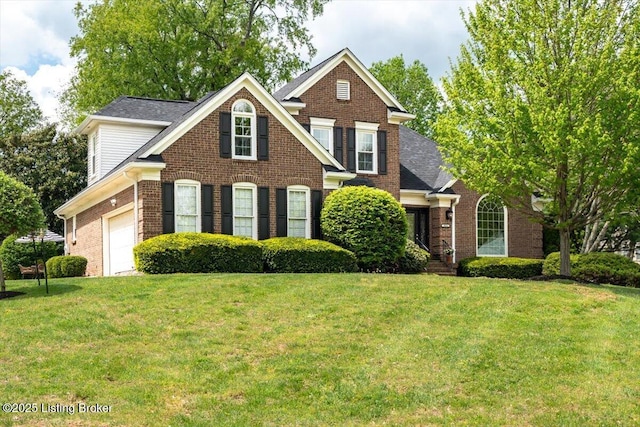 traditional home with a front yard and brick siding