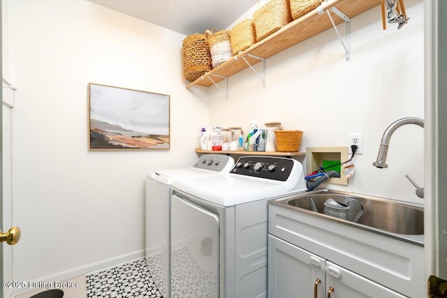 laundry room with washer and dryer, baseboards, cabinet space, and a sink