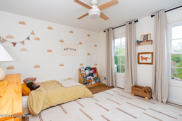bedroom featuring wood finished floors and baseboards