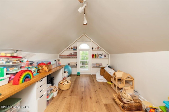 recreation room featuring light wood-type flooring and lofted ceiling