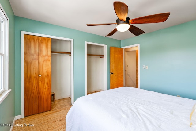 1527 Goddard Ave, Louisville, KY 40204 - bedroom with multiple closets, light wood-style flooring, ceiling fan, and baseboards
