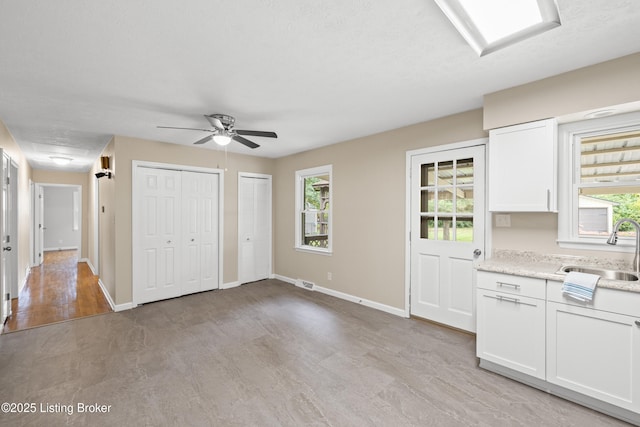 150 Joy St, Lawrenceburg, KY 40342 - interior space featuring light wood finished floors, a sink, white cabinets, and a wealth of natural light
