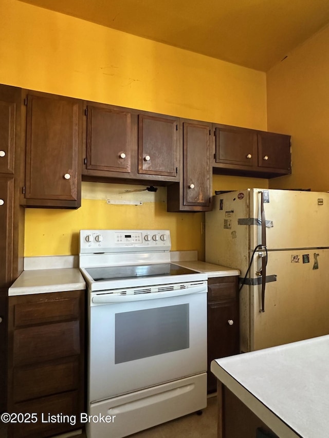 1460 S 6th St, Louisville, KY 40208 - kitchen featuring light countertops, dark brown cabinets, and white appliances