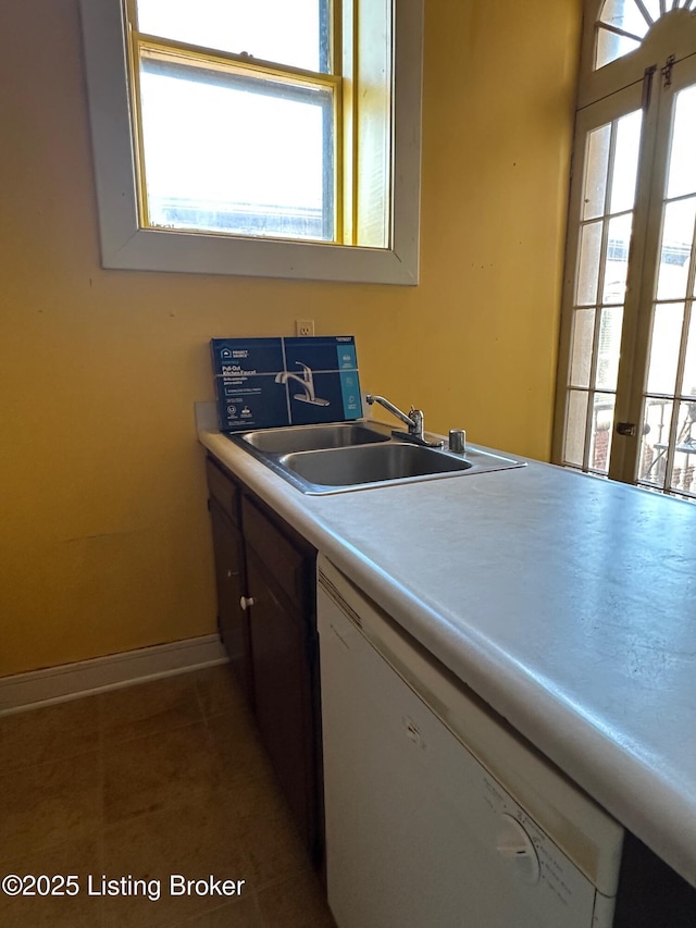 1460 S 6th St, Louisville, KY 40208 - kitchen featuring a sink, light countertops, tile patterned floors, baseboards, and dishwasher