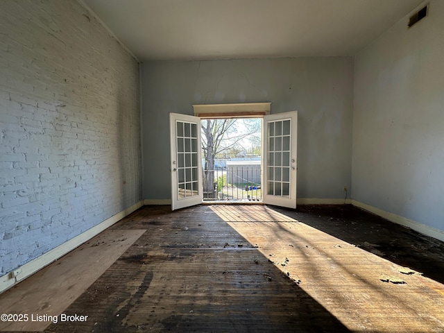 1460 S 6th St, Louisville, KY 40208 - empty room featuring visible vents, hardwood / wood-style floors, french doors, and baseboards