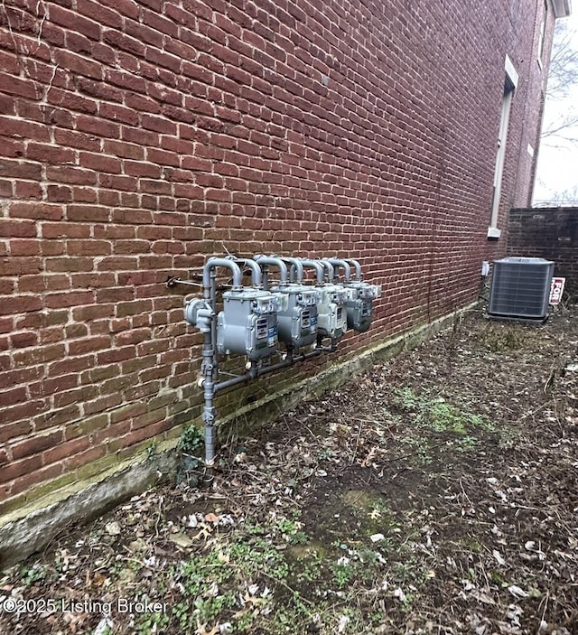 1460 S 6th St, Louisville, KY 40208 - details with fence, central AC unit, gas meter, and brick siding
