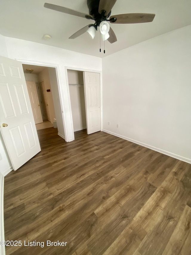 unfurnished bedroom featuring dark wood-style floors, a closet, ceiling fan, and baseboards