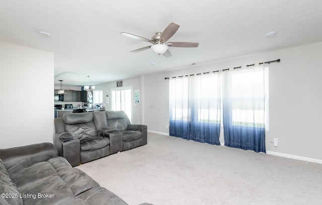 carpeted living area with baseboards, visible vents, and ceiling fan
