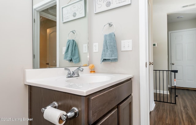 bathroom featuring visible vents, wood finished floors, and vanity