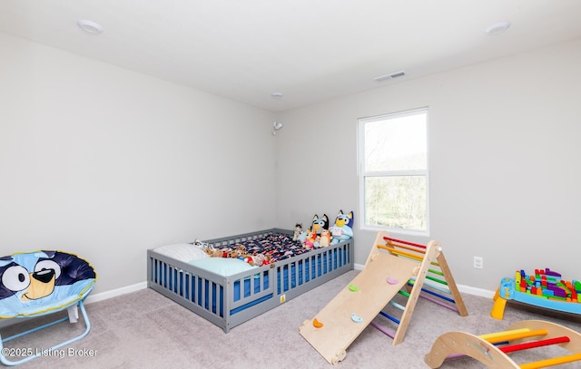 carpeted bedroom with baseboards and visible vents