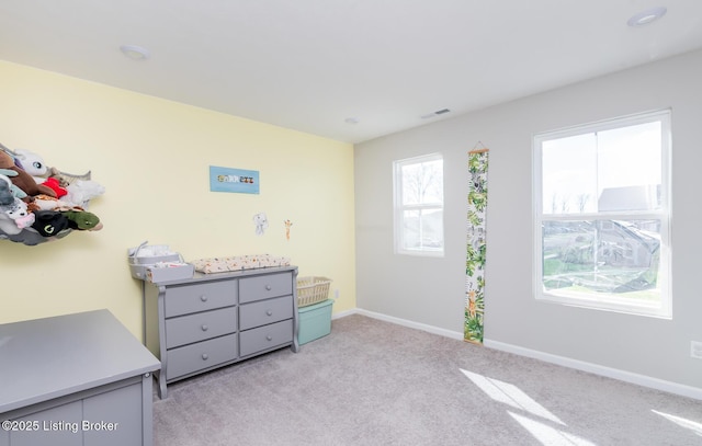 bedroom featuring visible vents, baseboards, and light carpet