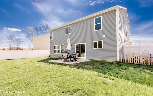 rear view of house with a lawn, a patio, and a fenced backyard