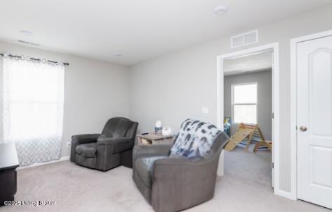 living room with visible vents and carpet