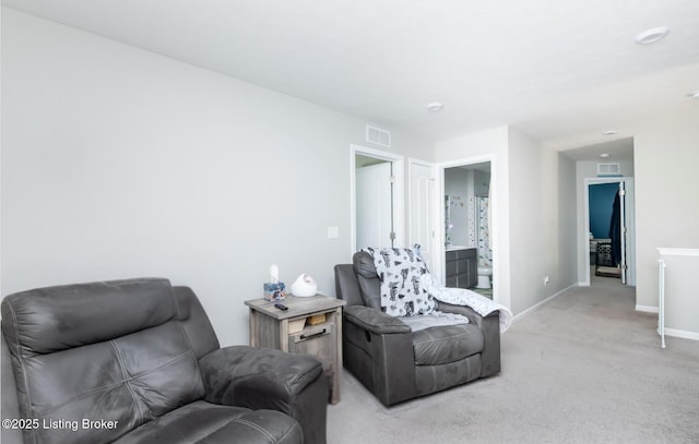 living room featuring baseboards, visible vents, and light colored carpet