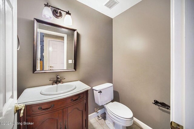 bathroom with vanity, tile patterned floors, toilet, visible vents, and baseboards