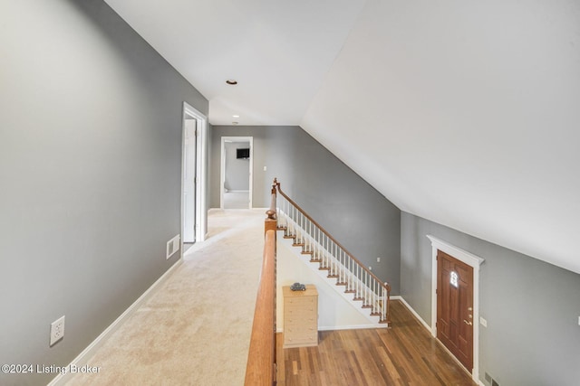 interior space featuring recessed lighting, an upstairs landing, visible vents, baseboards, and wood finished floors