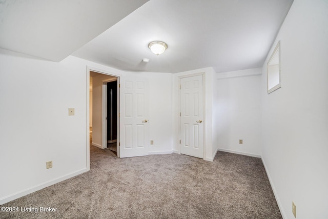 interior space featuring carpet floors and baseboards