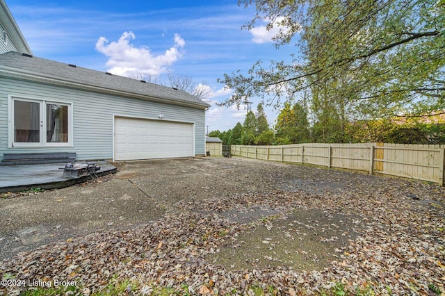 exterior space with fence and driveway