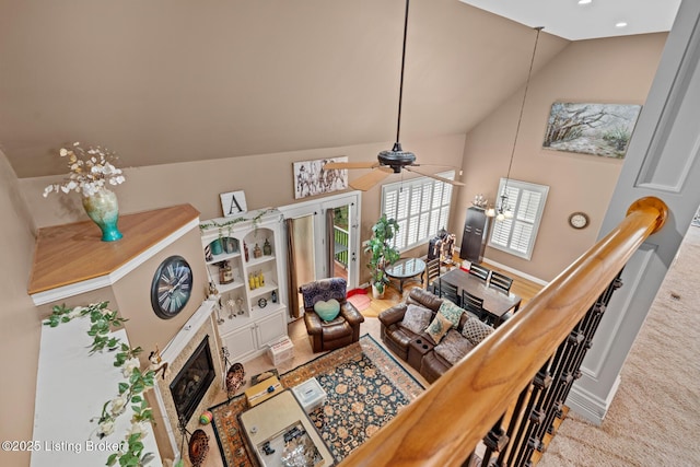 14729 Forbes Cir, Louisville, KY 40245 - living area with ceiling fan, high vaulted ceiling, a glass covered fireplace, carpet, and baseboards