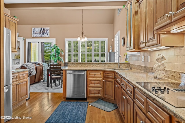 14729 Forbes Cir, Louisville, KY 40245 - kitchen with a sink, a chandelier, stainless steel appliances, tasteful backsplash, and light wood-style flooring
