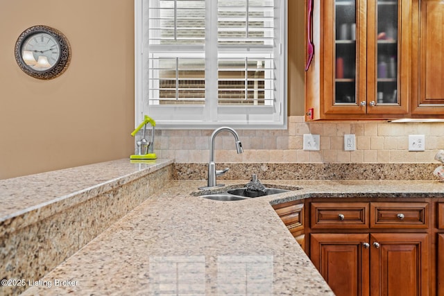 14729 Forbes Cir, Louisville, KY 40245 - kitchen featuring glass insert cabinets, backsplash, a sink, and brown cabinets