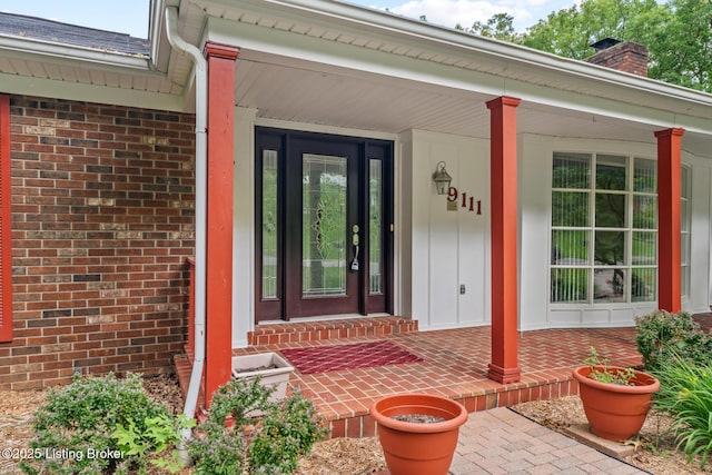 9111 Royal Oak Dr, Louisville, KY 40272 - doorway to property featuring brick siding, a chimney, and a porch