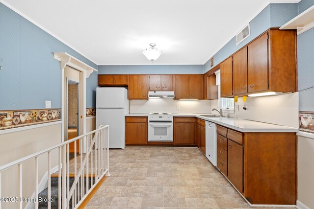 9111 Royal Oak Dr, Louisville, KY 40272 - kitchen with white appliances, under cabinet range hood, brown cabinetry, a sink, and light countertops