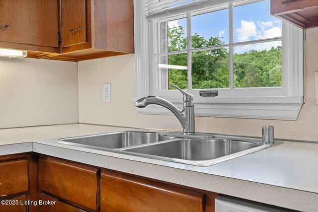 9111 Royal Oak Dr, Louisville, KY 40272 - kitchen featuring a sink, light countertops, and brown cabinetry