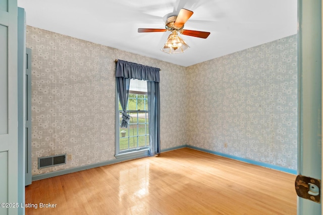 9111 Royal Oak Dr, Louisville, KY 40272 - empty room with wood finished floors, baseboards, ceiling fan, and wallpapered walls