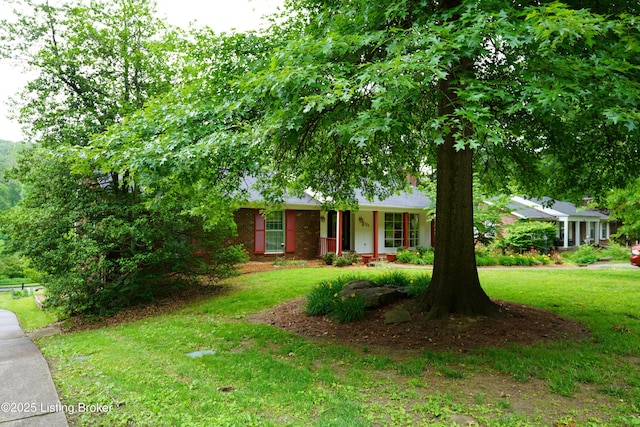 9111 Royal Oak Dr, Louisville, KY 40272 - view of front of house featuring a front yard, brick siding, and covered porch