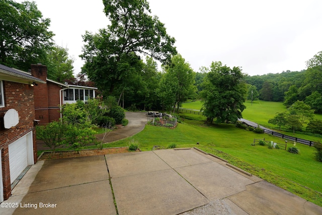 9111 Royal Oak Dr, Louisville, KY 40272 - view of patio with an attached garage and concrete driveway