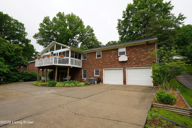 9111 Royal Oak Dr, Louisville, KY 40272 - view of front of home with brick siding, an attached garage, concrete driveway, and central air condition unit