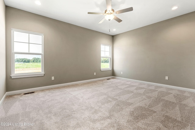 carpeted empty room with recessed lighting, visible vents, ceiling fan, and baseboards
