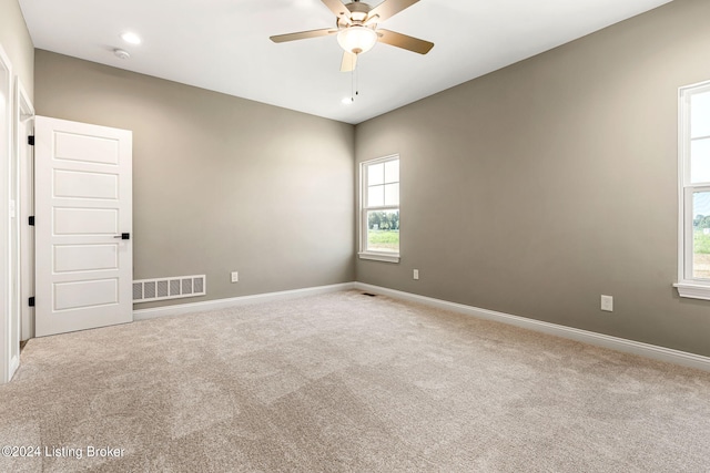 carpeted empty room featuring baseboards, visible vents, a ceiling fan, and recessed lighting