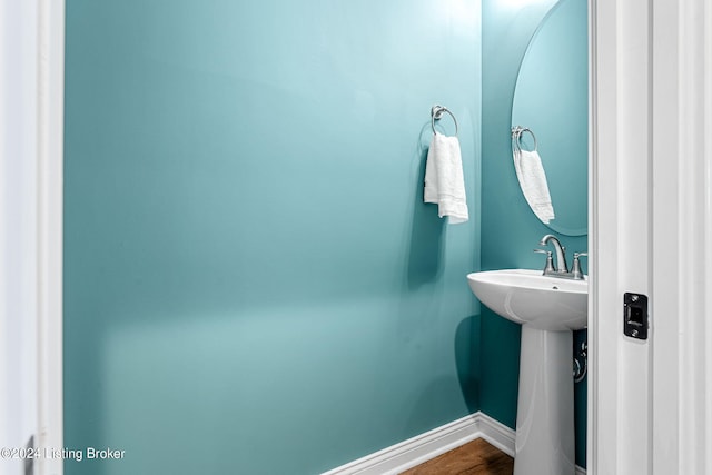 bathroom with wood finished floors and baseboards