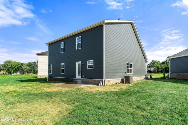 back of property featuring central AC, entry steps, and a yard