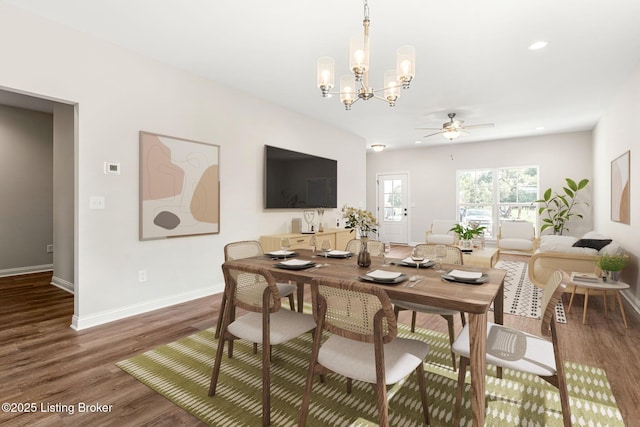 dining area featuring baseboards, recessed lighting, wood finished floors, and ceiling fan with notable chandelier