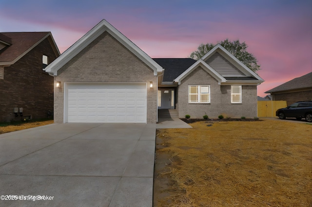 ranch-style home featuring concrete driveway, a garage, and brick siding
