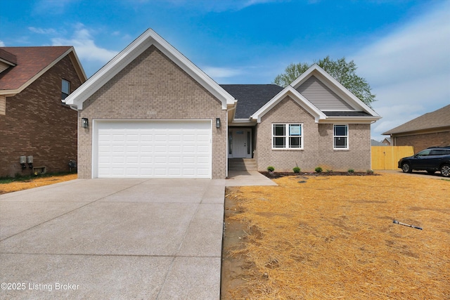 single story home featuring a garage, brick siding, fence, and concrete driveway