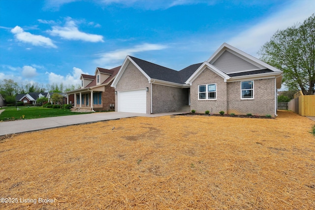 ranch-style home featuring brick siding, fence, a front lawn, concrete driveway, and an attached garage