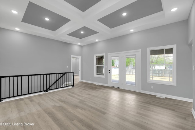 unfurnished room with visible vents, coffered ceiling, baseboards, recessed lighting, and wood finished floors