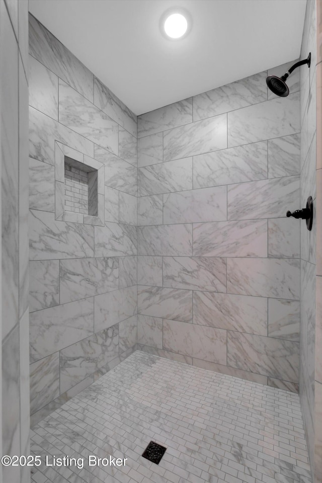 full bath with a tile shower