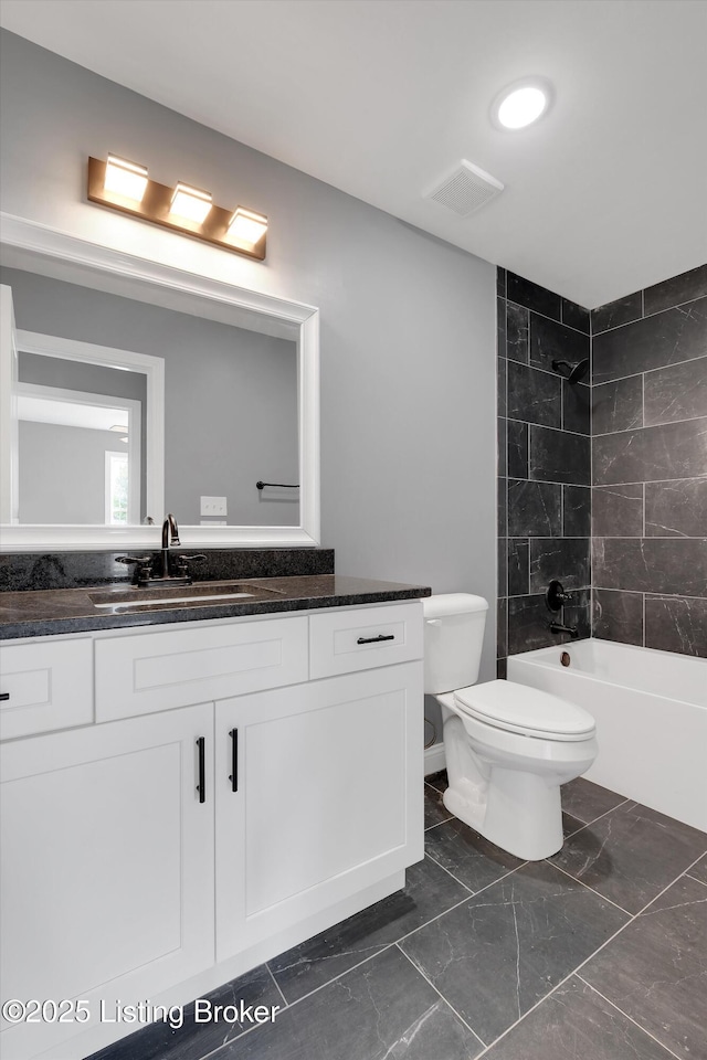 full bathroom featuring visible vents, toilet, shower / bathing tub combination, vanity, and marble finish floor