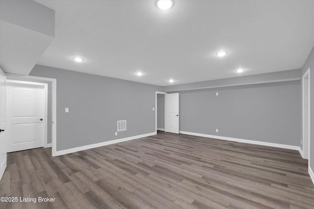 finished basement with recessed lighting, visible vents, wood finished floors, and baseboards